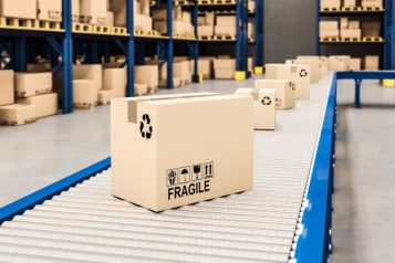 Warehouse with conveyor belt and fragile boxes on it