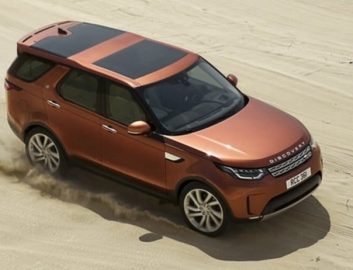 Brown car driving in desert