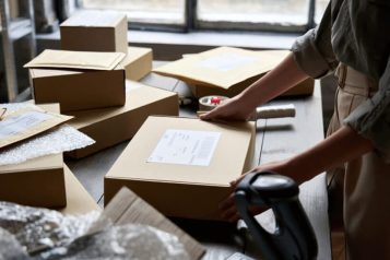 Warehouse employee preparing a box for an order
